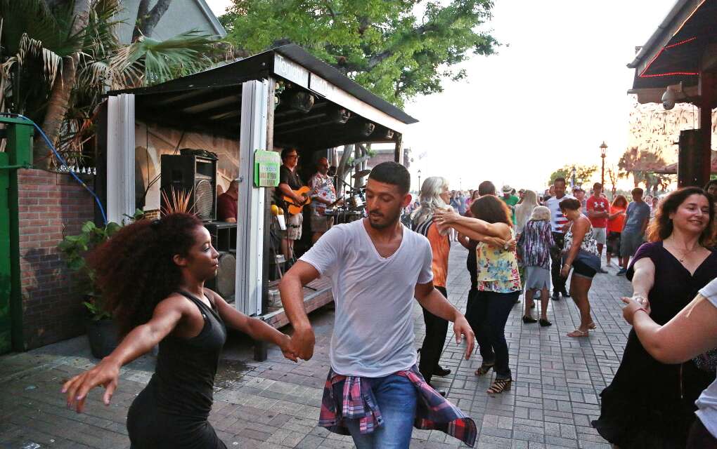 Dancers move to a Latin beat outside of El Meson De Pepe Restaurant and Bar at Mallory Square in Key West. 