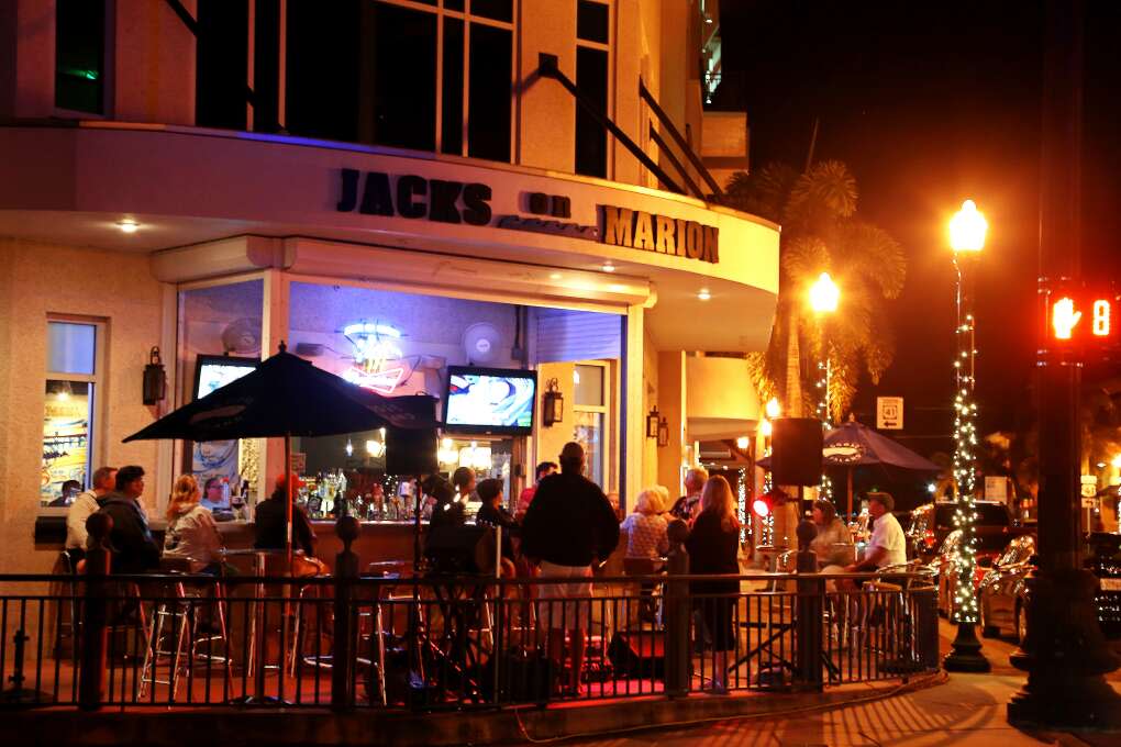 The Saturday night crowd enjoys sidewalk music at Jacks On Marion in downtown Punta Gorda after dark. The area is home to several restaurants, bars, and hotels near the Peace River. 
