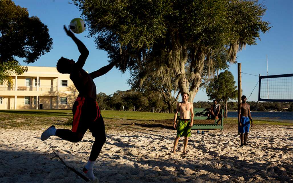 Students at Webber International University in Babson Park, which is along the Ridge Scenic Highway, play volleyball between classes.