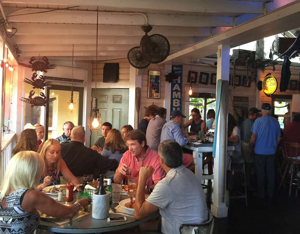 Diners enjoy dinner at Owen's Fish Camp in Sarasota. The business serves mostly local seafood updating Southern classics.  