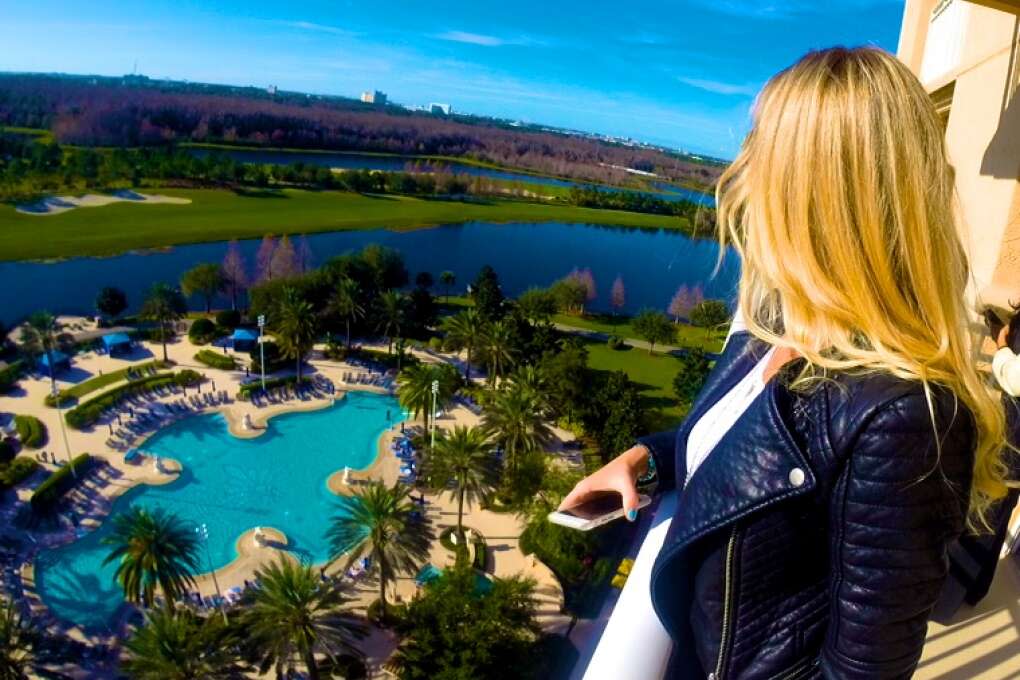 Woman viewing all of Orlando from the top of the Royal Suuite at the Ritz Carlton