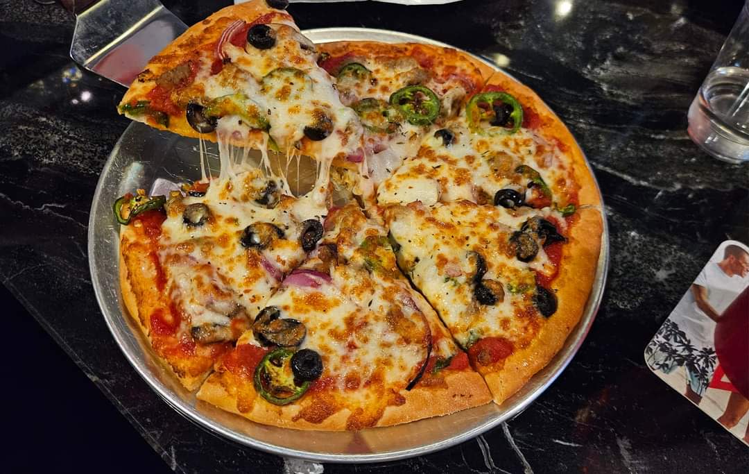 A slice of pizza is served at JJ Beard's