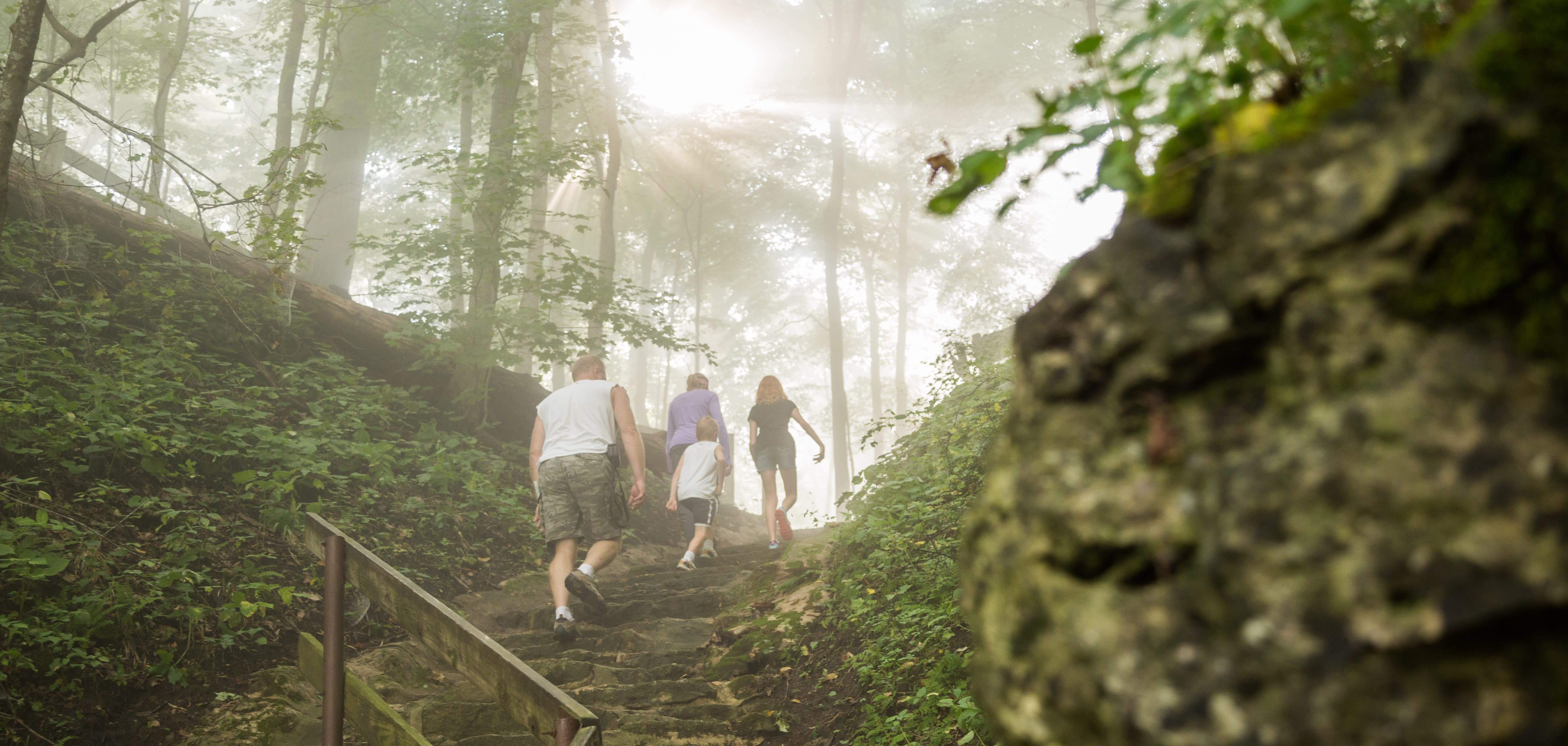 Family of four hiking up stairs at Wyalusing State Park