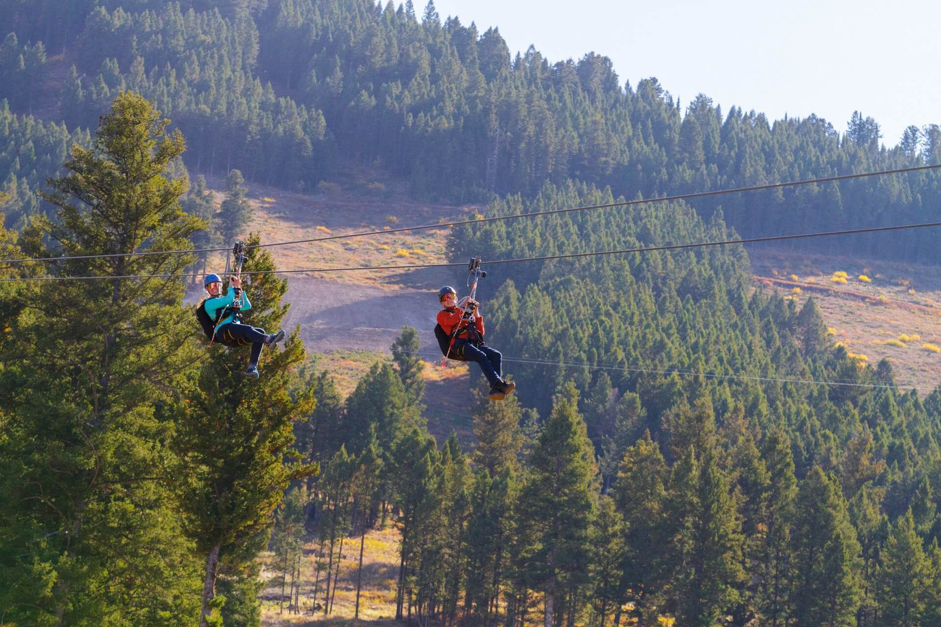 Visitors zipline down Snow King as part of an adventure getaway.