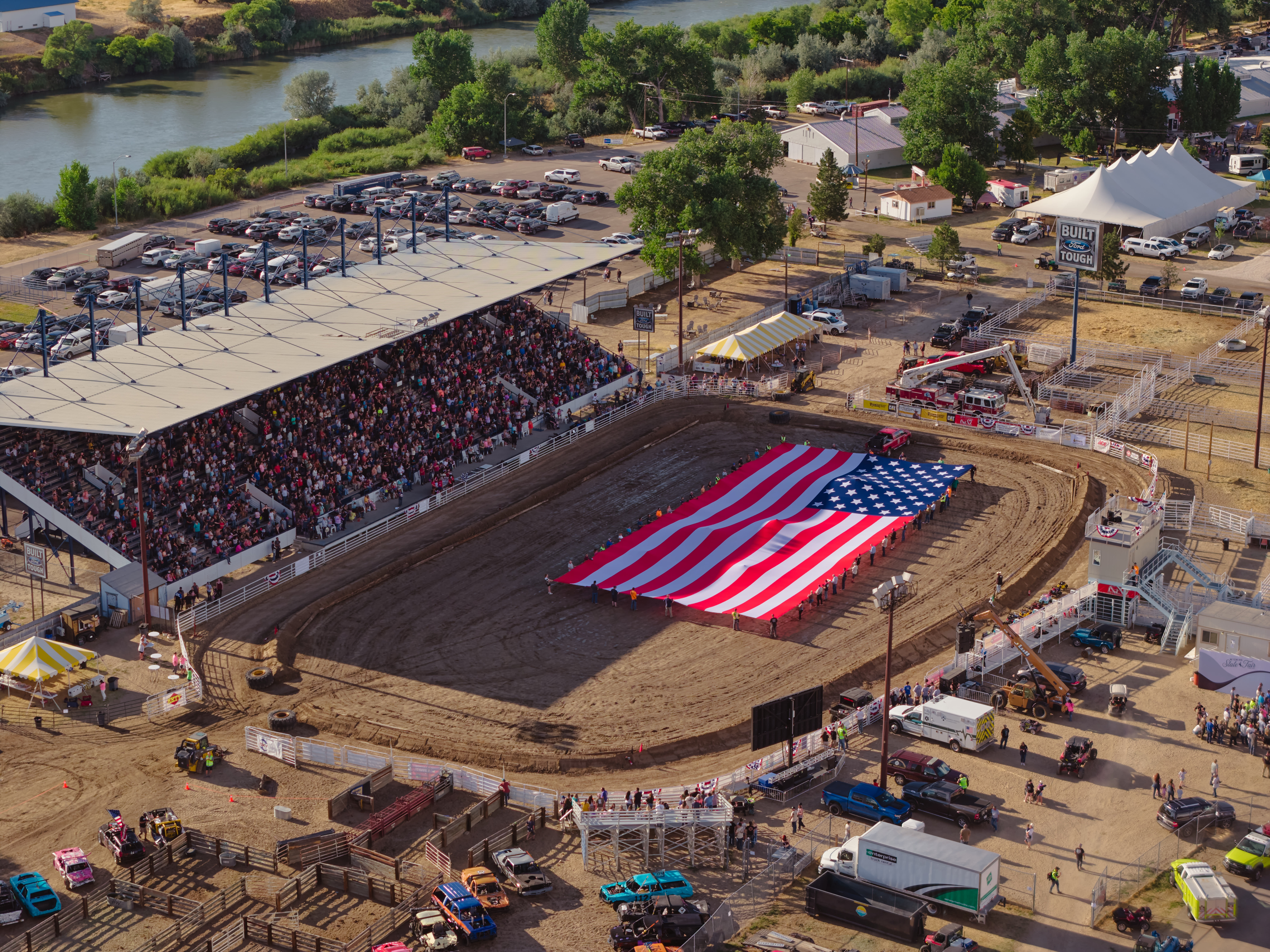 An American flag in the middle of the Wyoming State Fair grounds during a rodeo.