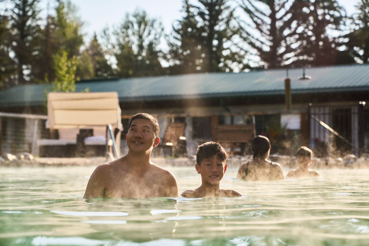 people soaking in warm water of hotsprings at a hotel