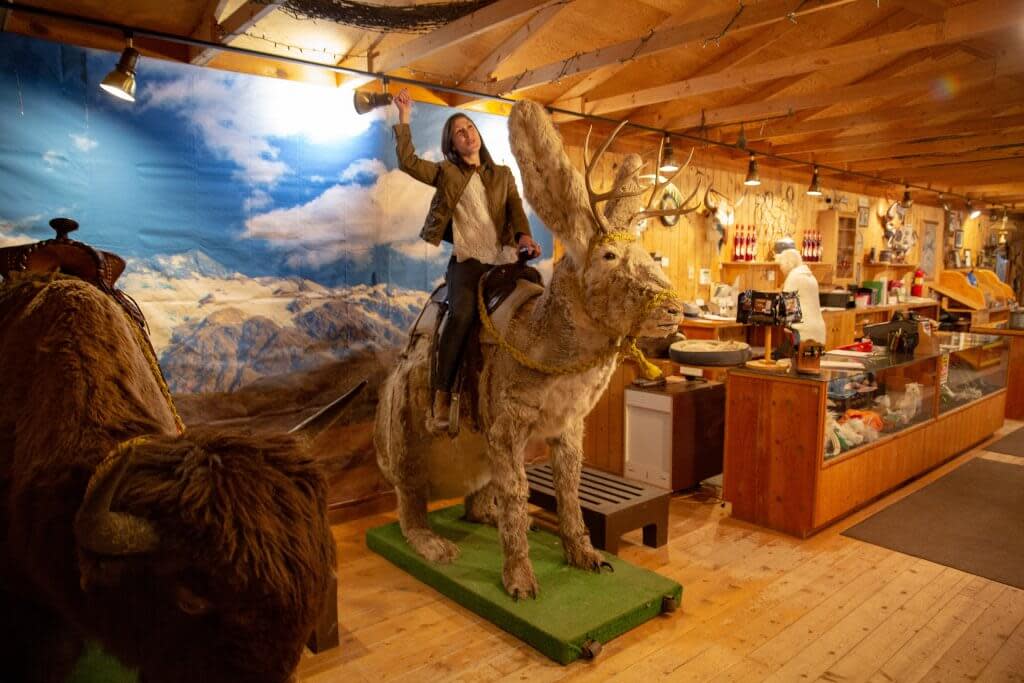 Woman on Jackalope sculpture inside Terry Bison Ranch in Wyoming. 