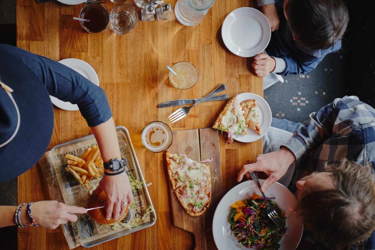 Family eating pizza, burgers and a salad at the Mangy Moose in Jackson, Wyoming.