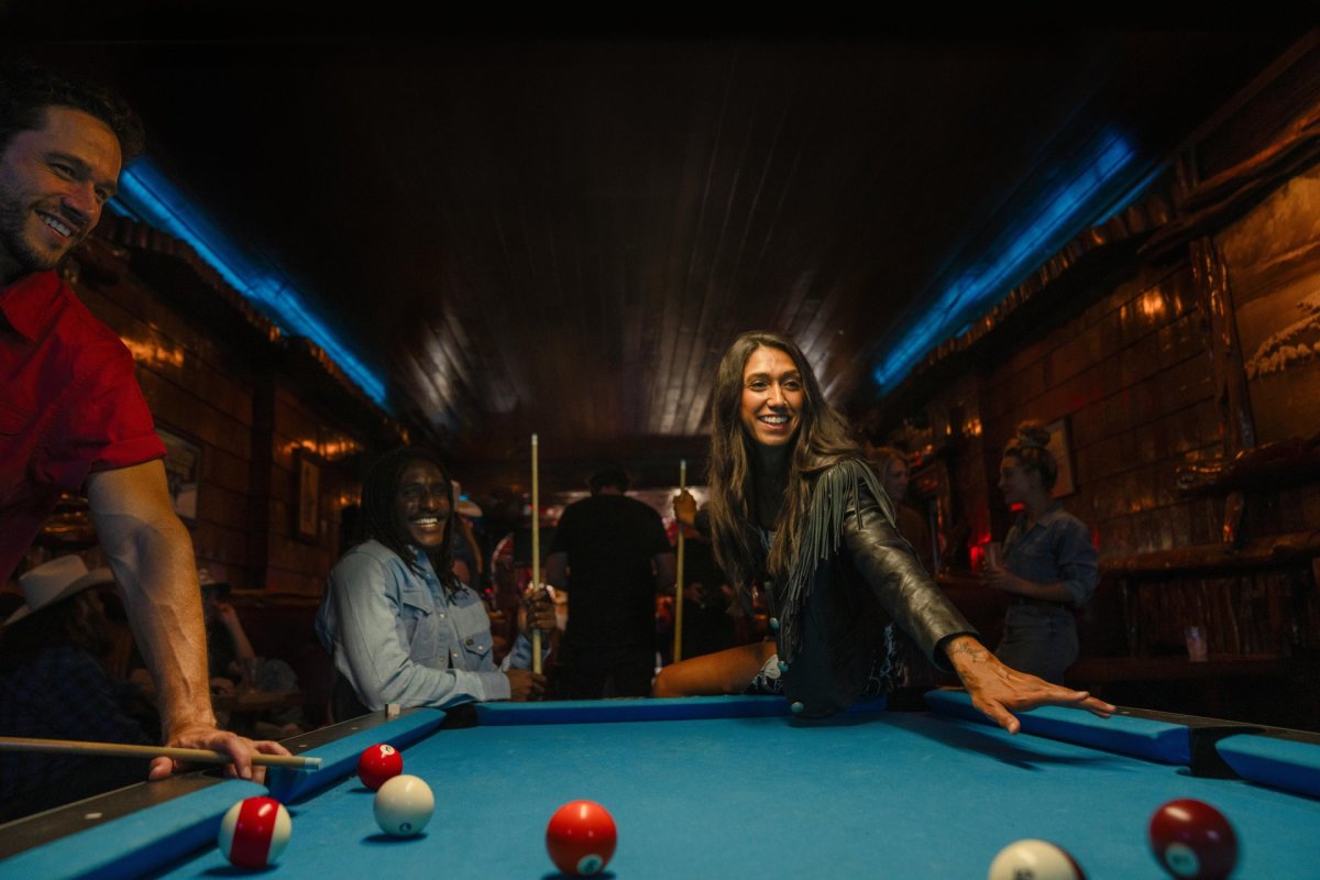 Group of people playing pool at the Mint Bar.