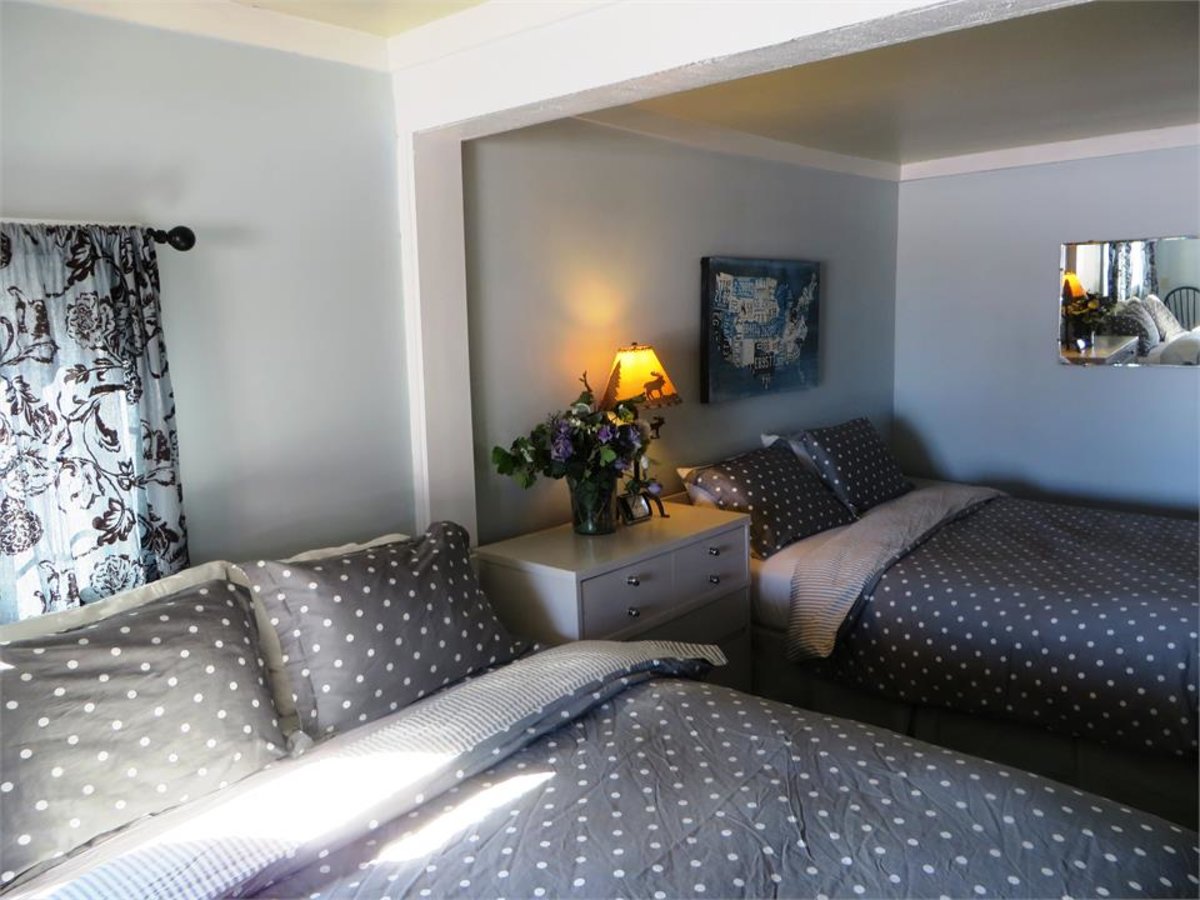 Inside of a hotel room with 2 beds in the Log Cabin Hotel located in Pinedale Wyoming