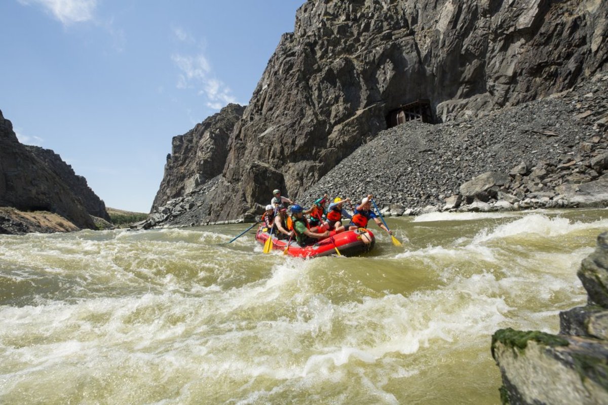 A group of people whitewater rafting through a lake in the Wind River Range