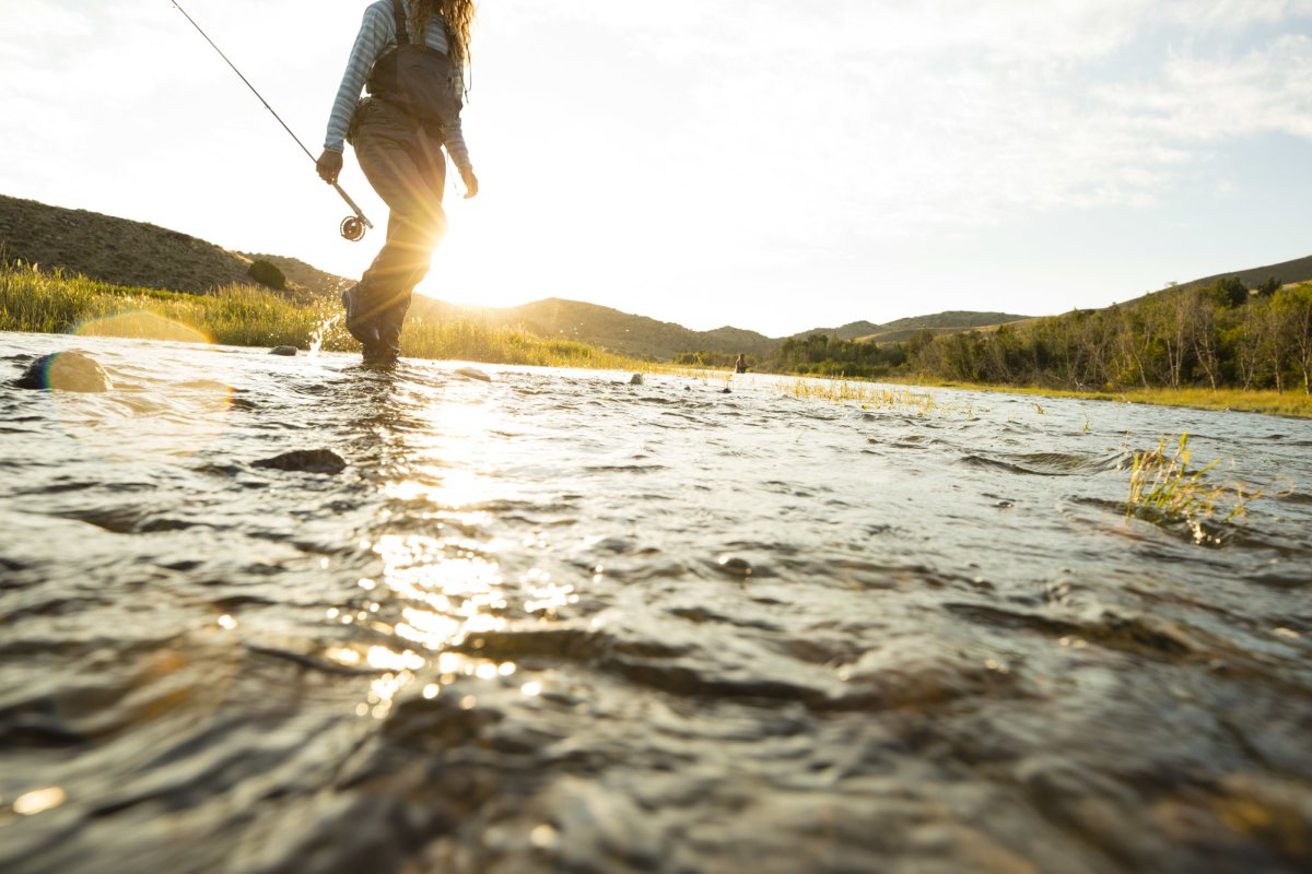 Woman fly fishing in a river.