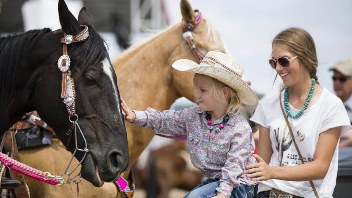 Family having fun traveling to Rodeo in Wyoming.