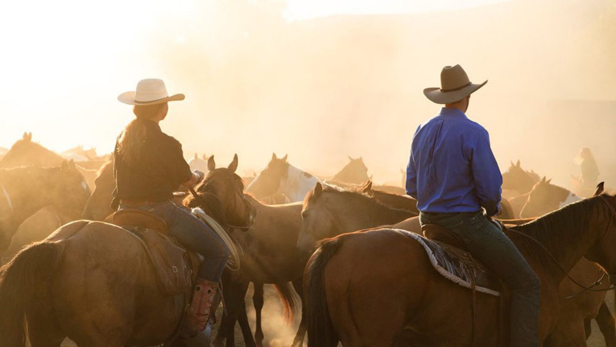 Guests riding horseback at a Wyoming guest ranch, a vacation spot that's popular or families.