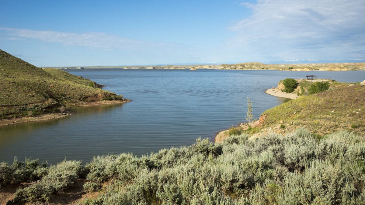 Boysen Reservoir, surrounded by green banks of land, a great place to ice fish in the winter.