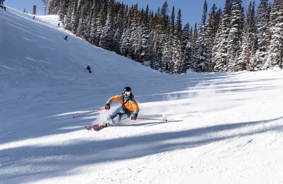 Skiers going down a snowy mountain at Jackson Hole Mountain Resort