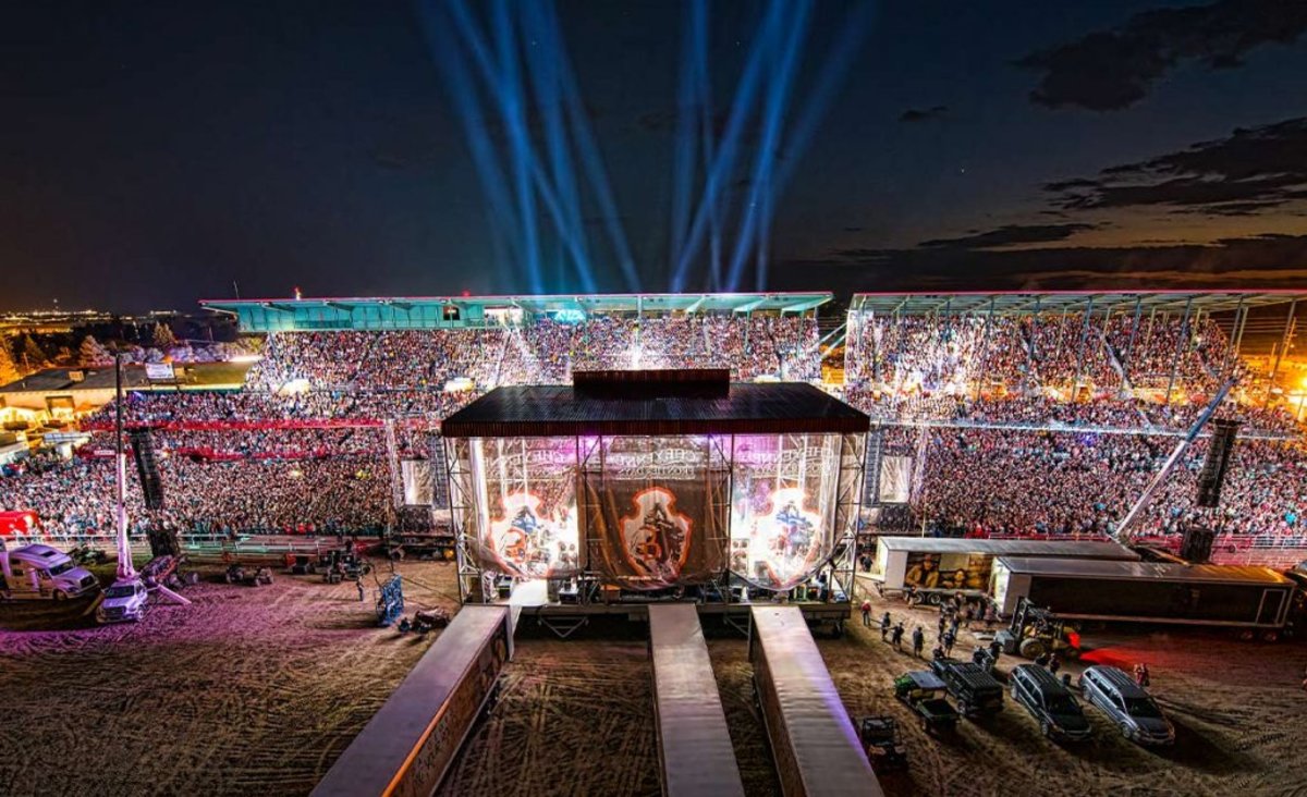 A top event in Wyoming, crowd gathers in an outdoor arena for a concert at the Cheyenne Frontier Days Rodeo.