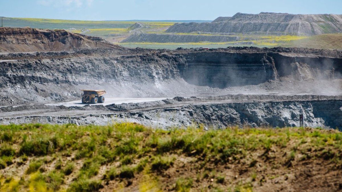 A dump truck amidst a sprawling rocky landscape at the Eagle Butte Coal Mine.