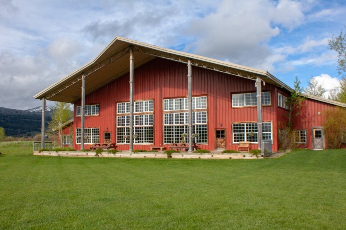 Red barn like exterior of Diamond Cross Ranch, one of the best wedding venues in Wyoming.