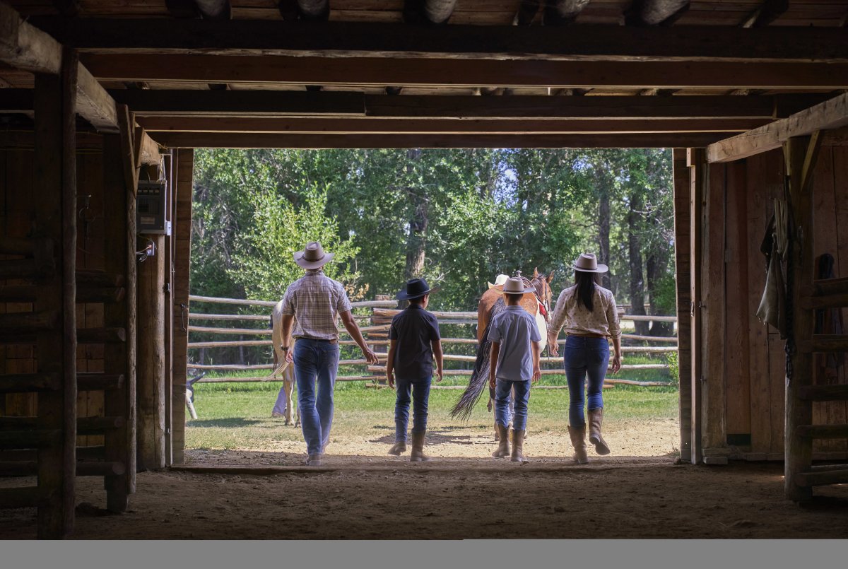 Family walking out of a barn.