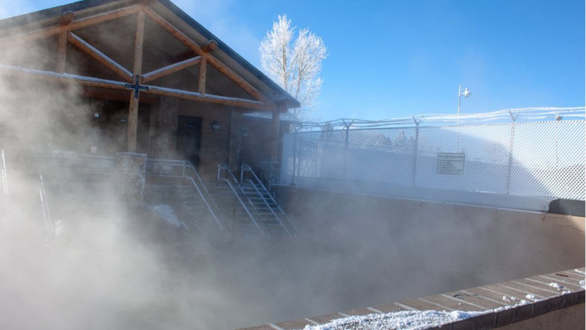 steam rising over hot springs pool at Hobo Pool in Wyoming 