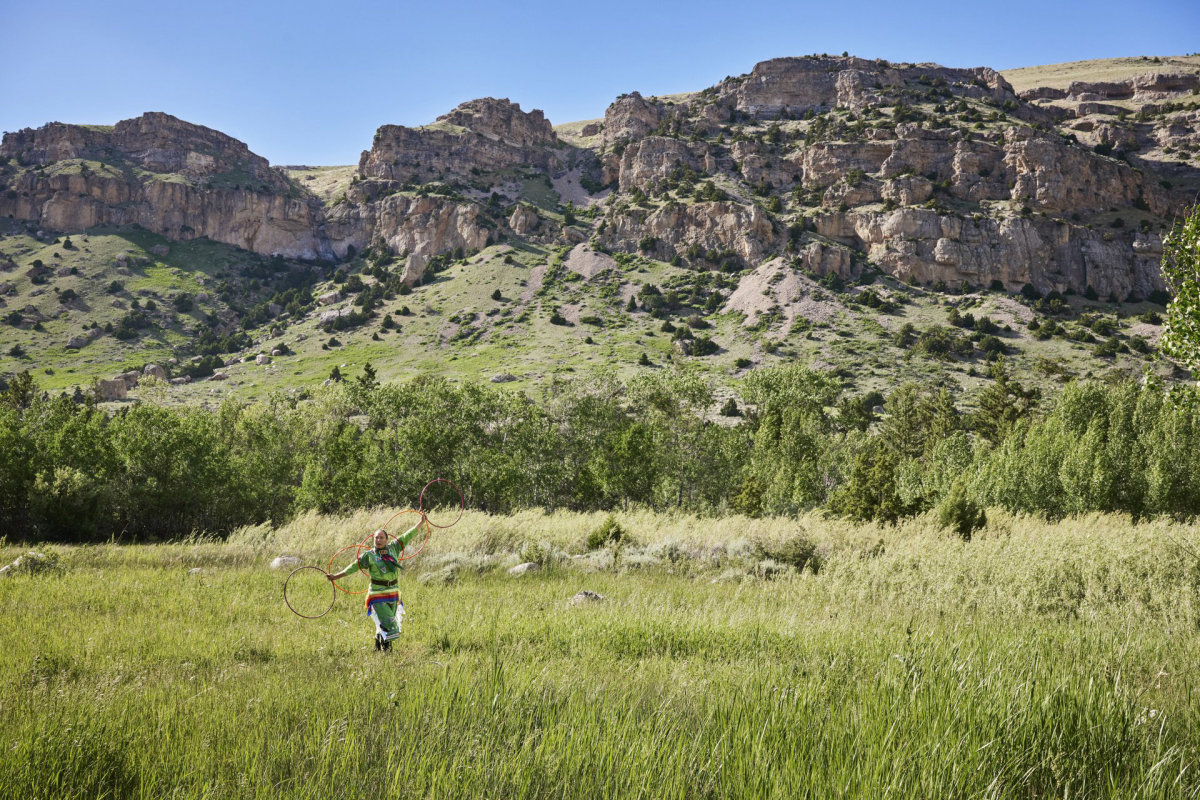 Hoop dancer in a field in Wind River country.