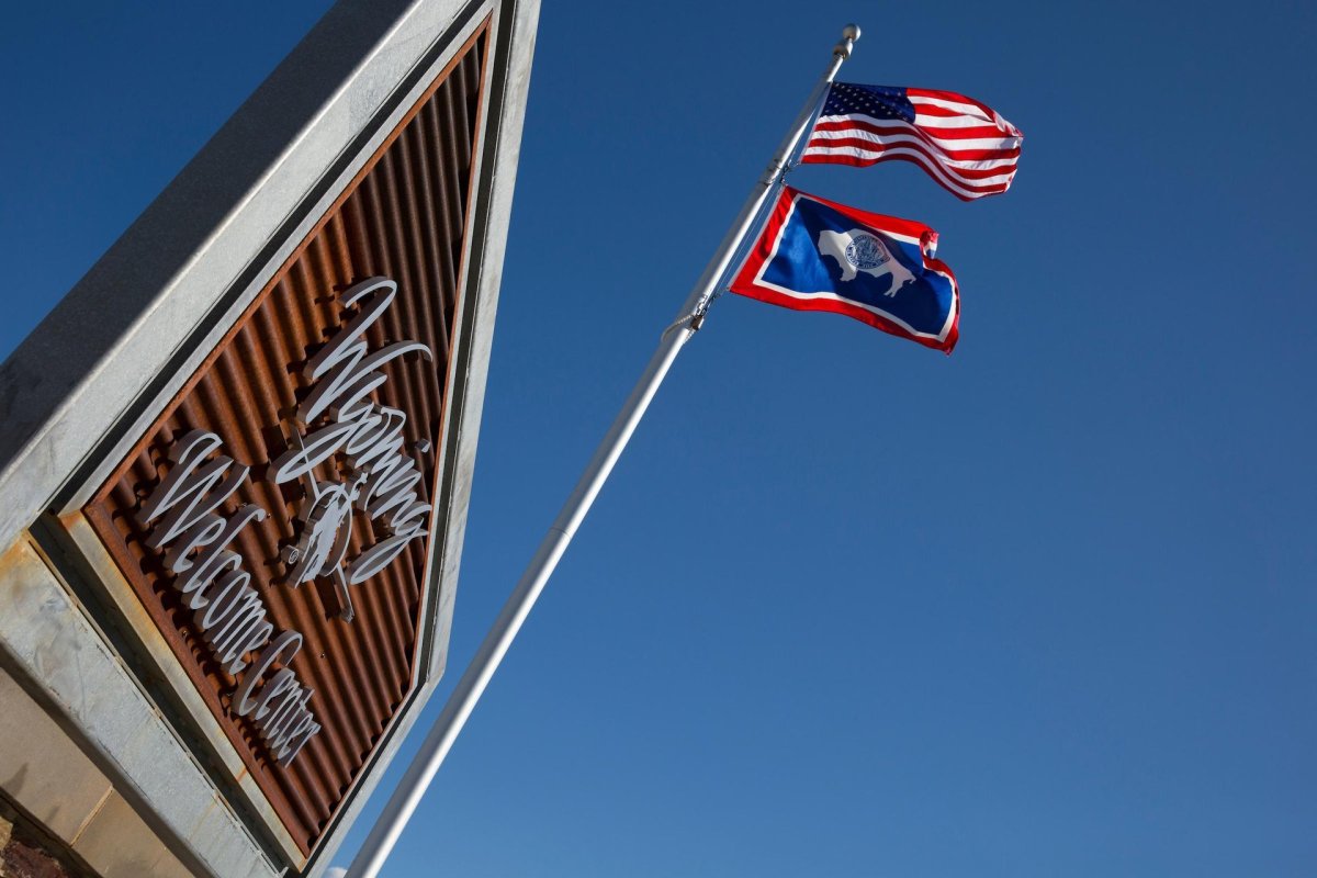 Welcome Center Sign with the American and Wyoming flags