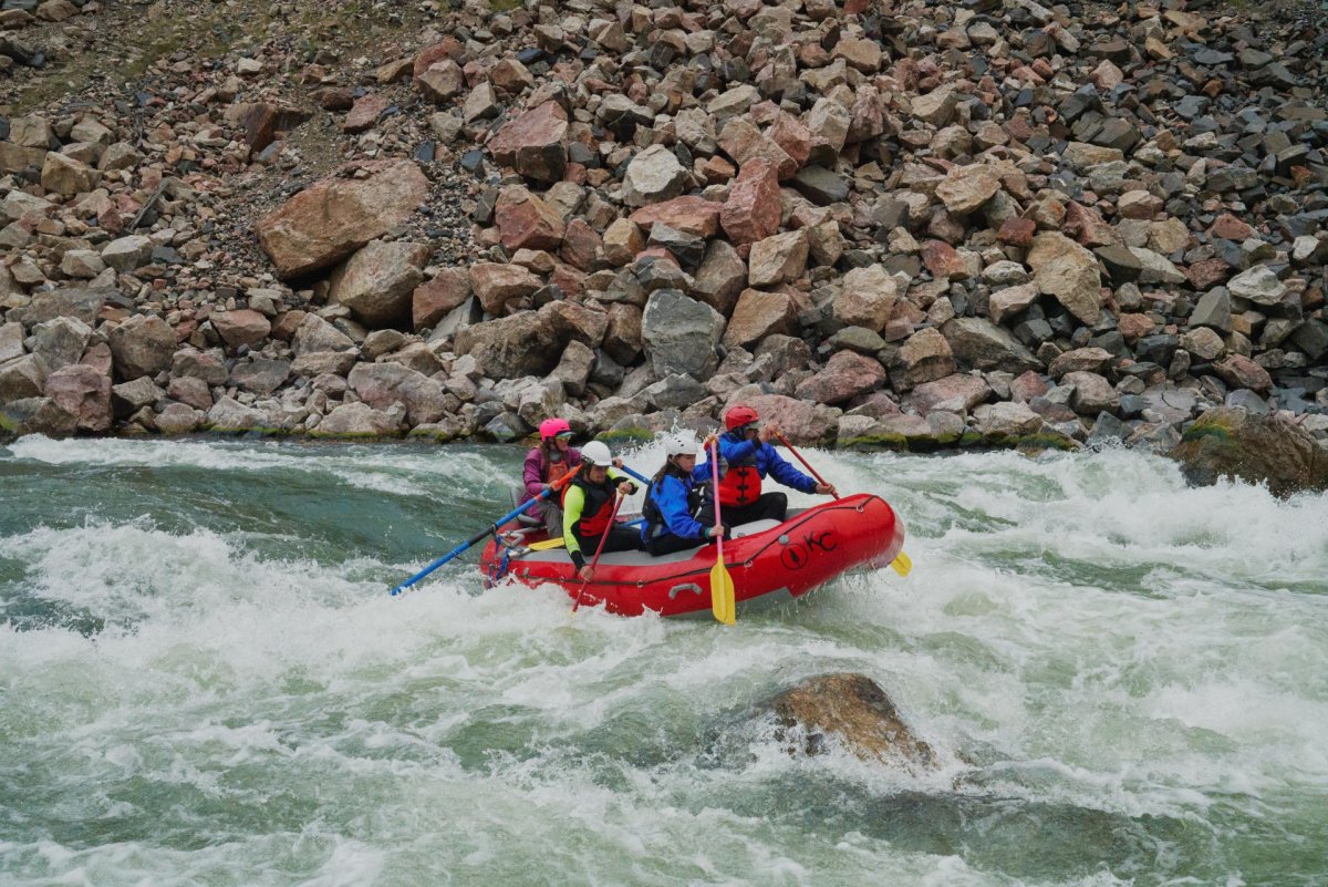 Group white water rafting down a river.
