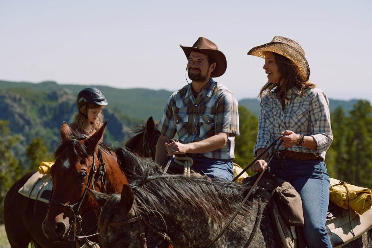 Family riding horses at a dude ranch.