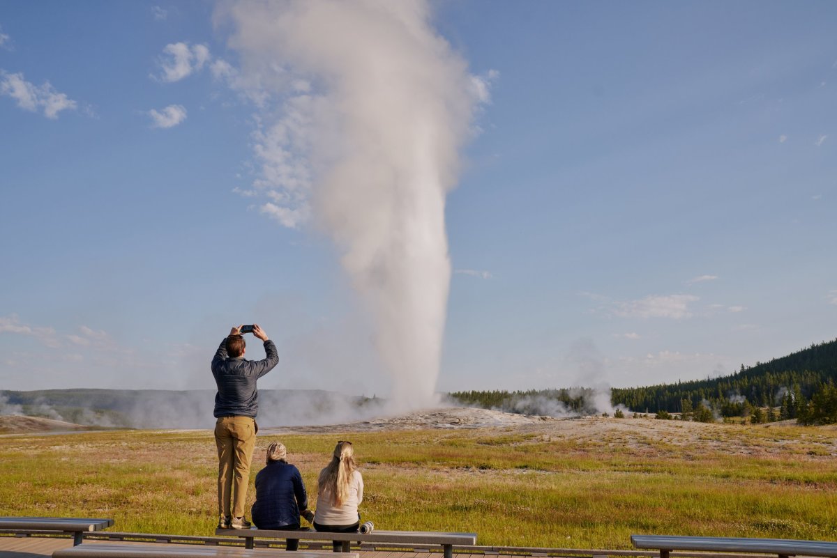 Family viewing the eruption of Old faithful