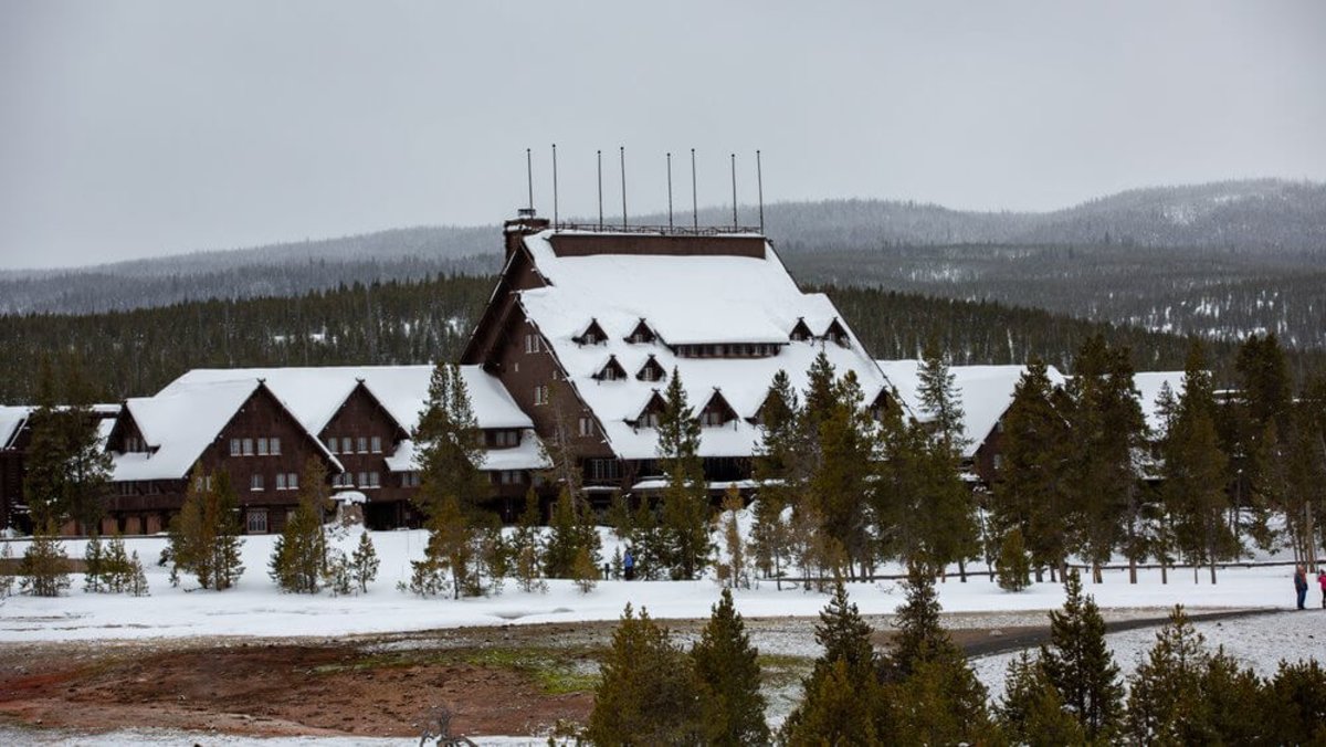 Old Faithful Snow Lodge & Cabins in Yellowstone covered in snow during the winter season.