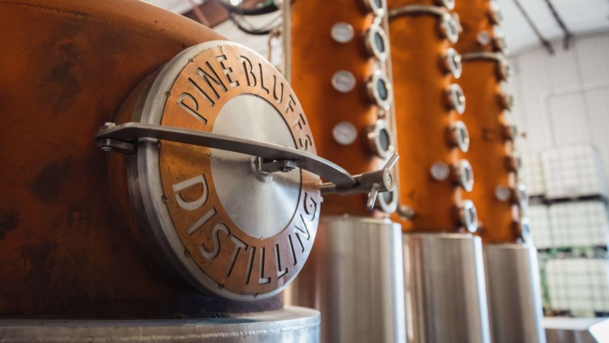 Pine Bluffs distilling equipment standing near the tasting room.