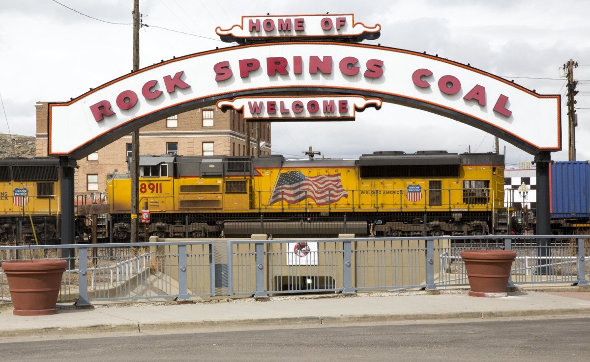 Rock Springs welcome sign with train engine in the background