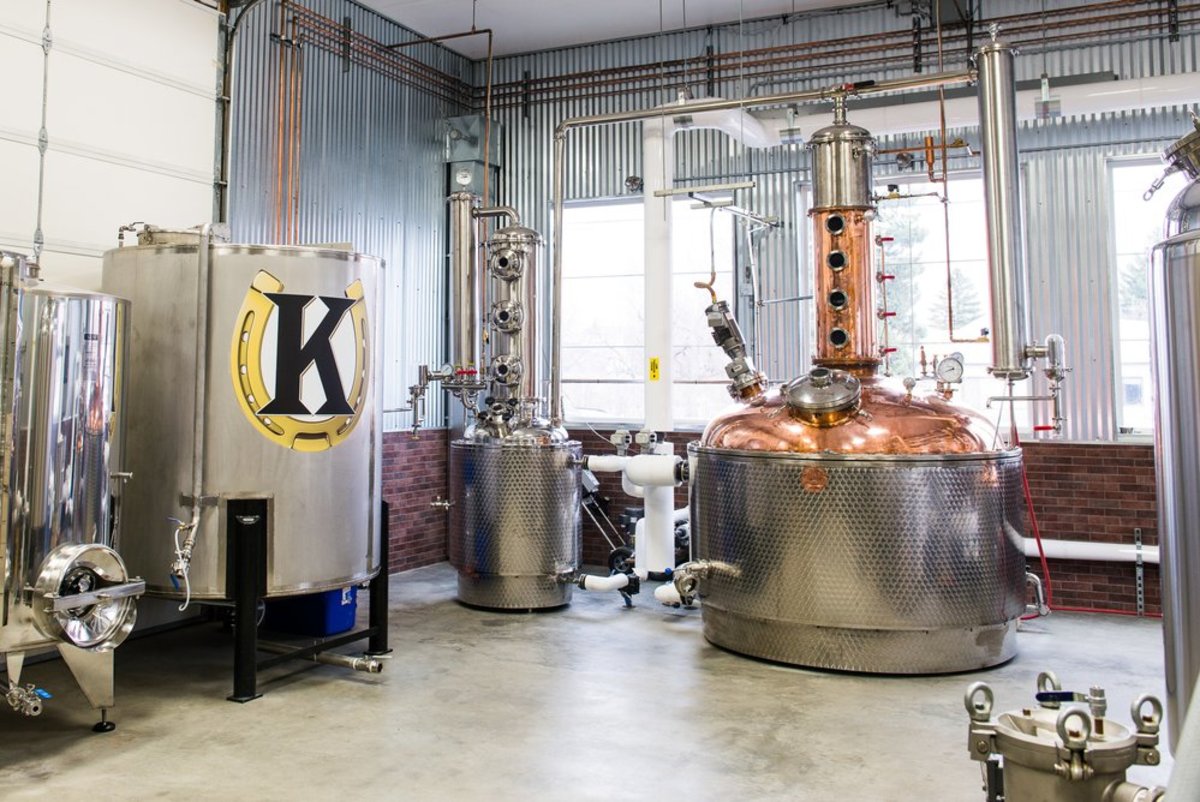 A view of the distillery room's behind-the-scenes production facilitiy in Koltiska Distillery in Sheridan, Wyoming, featuring the logo of a big K on a horsehoe on one of the machines.