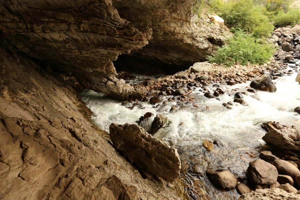 River running through a cave at Sinks Canyon State Park, a Wyoming landmark. 