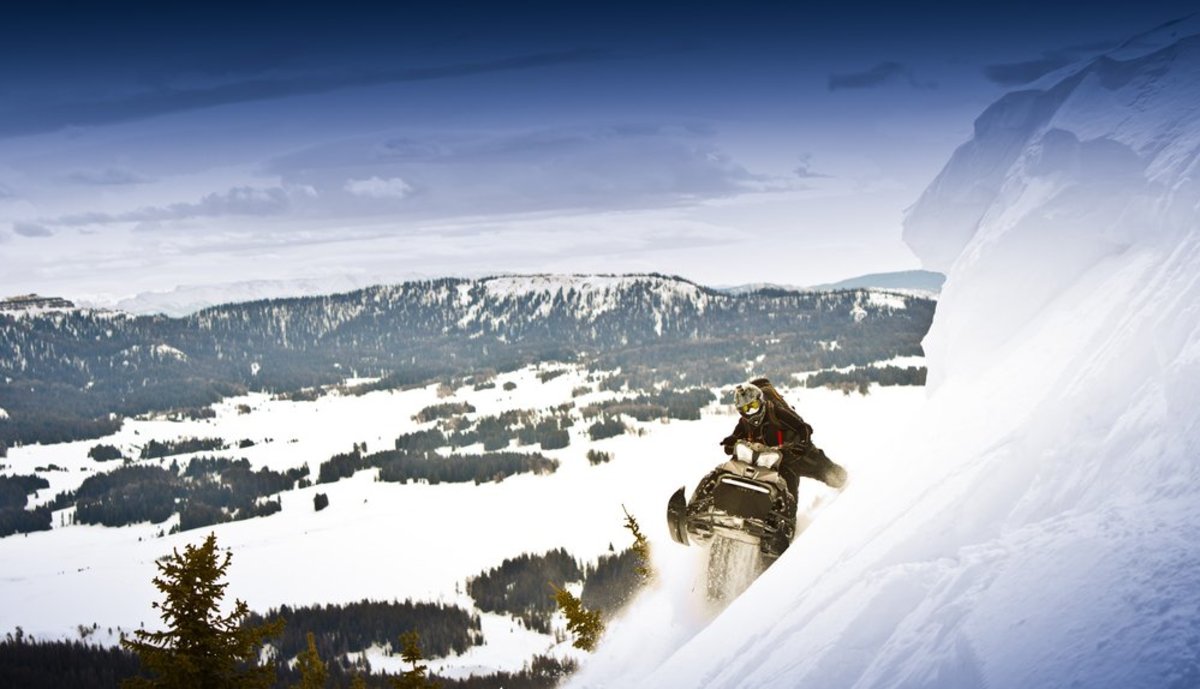 A snowmobiler riding through Snowy Range within the Medicine Bow National Forest.