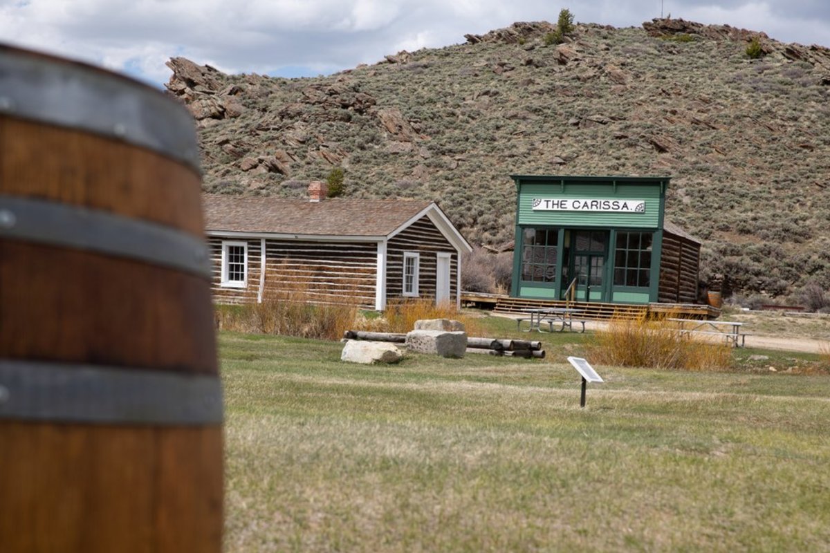South Pass City, a now deserted ghost town in Wyoming, has empty shops and a green landscape. 