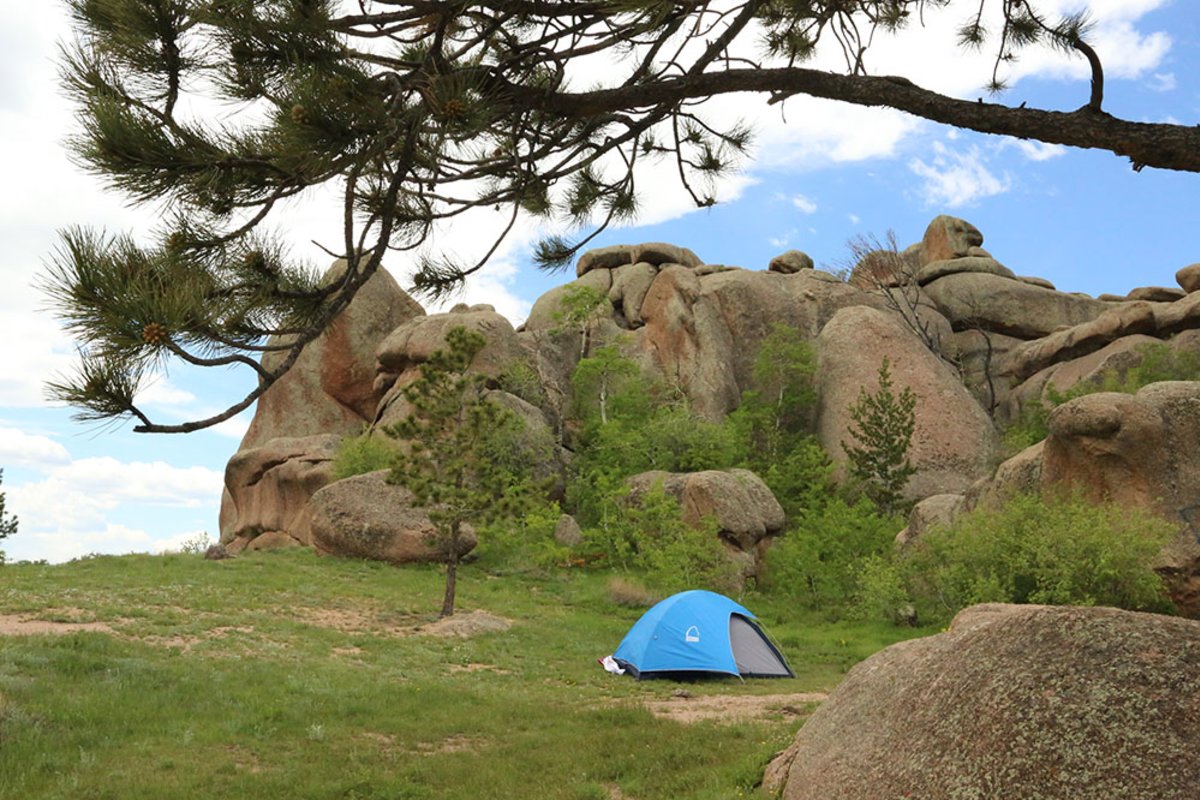 A campsite with big boulders in the background in Wyoming, during the summer.