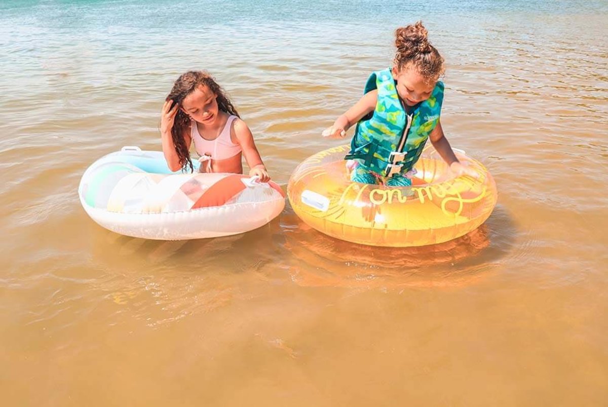 Two girls floating on the lake at Keystone