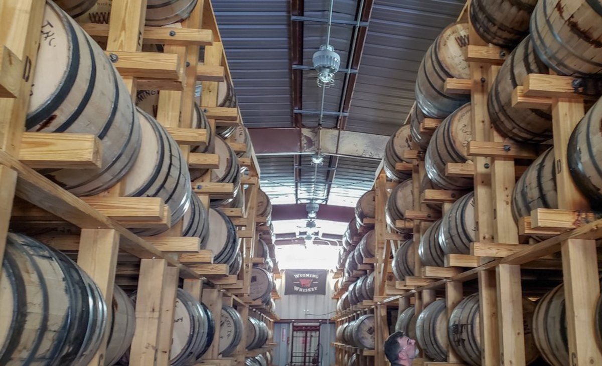 Rows of oak barrels stacked ceiling-high line the walls of Wyoming Whiskey, a popular craft distillery in Kirby, Wyoming.