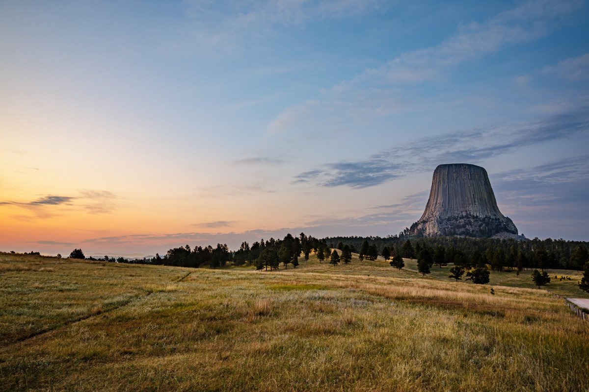 Devils Tower against a sunset sky