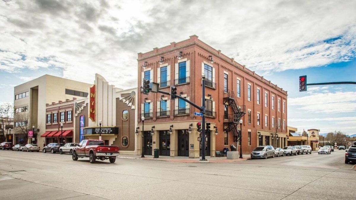 Clouds wisp in a blue sky above the historical main street in Sheridan, Wyoming, featuring the WYO Theater.