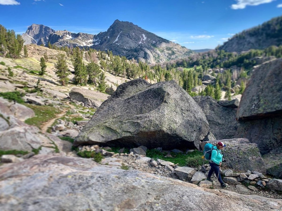 A woman hiking through the Wind River Range mountains in Wyoming 