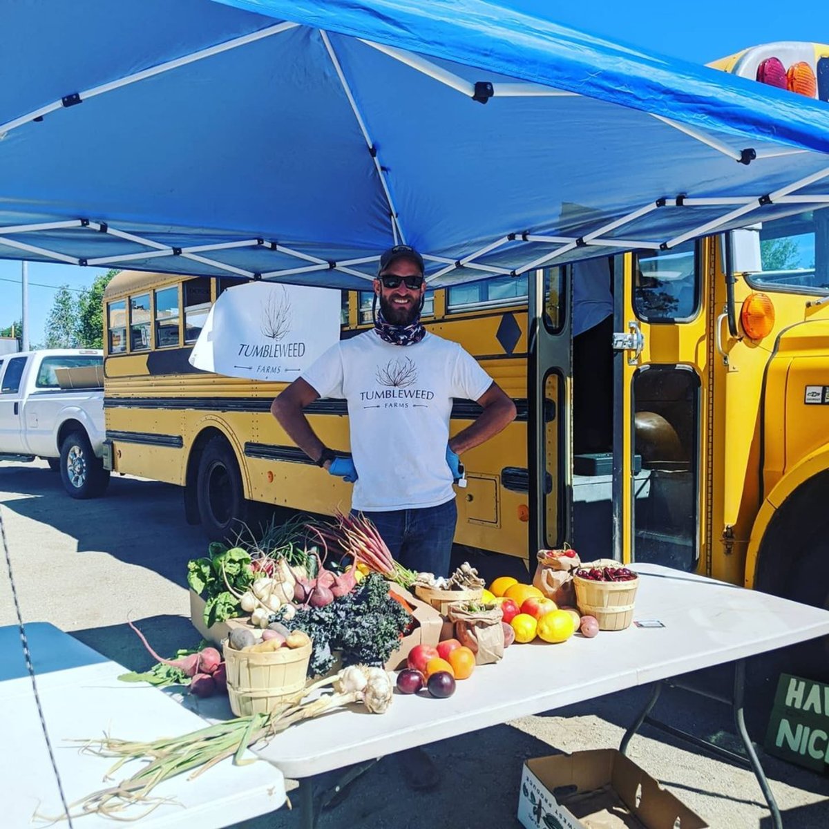 Man in front of a school bus with fresh produce in Wyoming