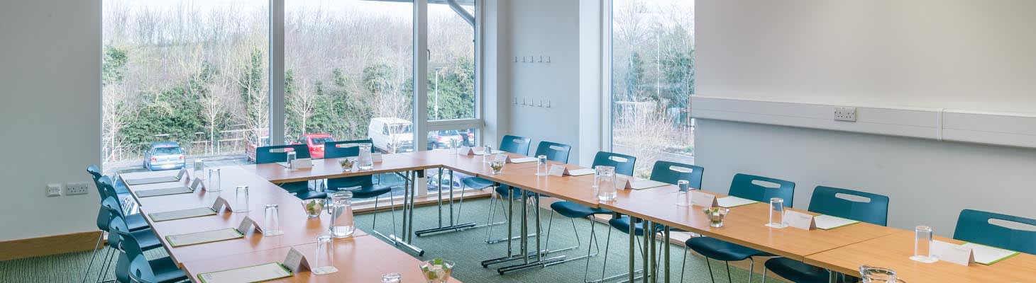 A bright meeting room set boardroom, ideal for day meetings.