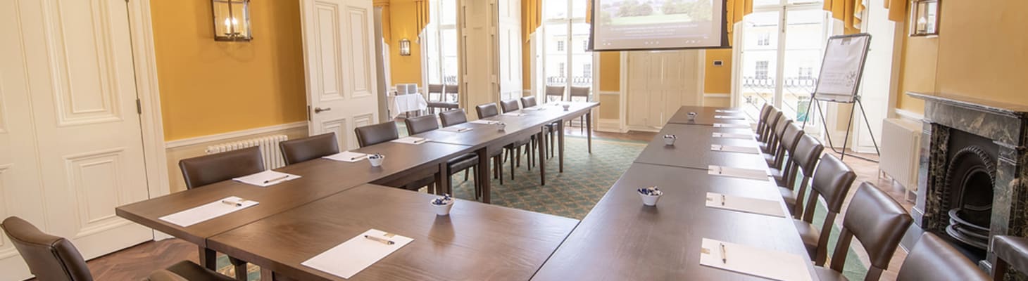 The Music Room at Downing College, Cambridge. A multi-functional meeting and event space, filled with natural light and set up in a u shape style.