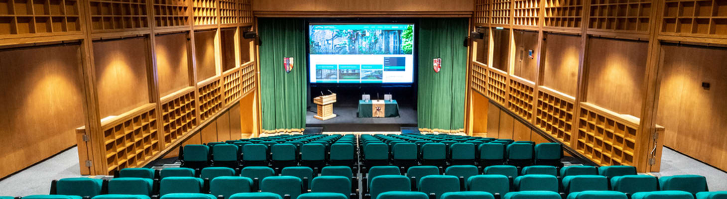 Fitzpatrick Hall is a modern auditorium with tiered seating and a large screen, great for conferences and presentations.