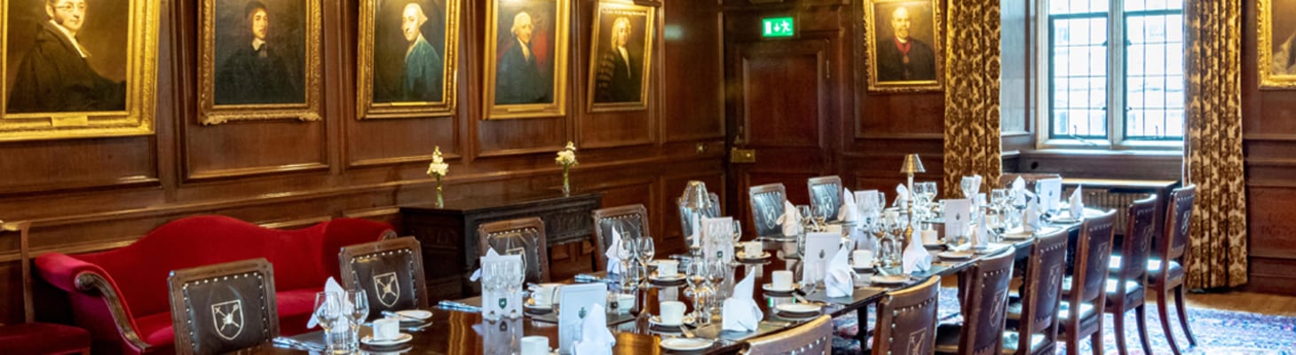 An oak panelled room, with log fires and old portraits set for a small private dining experience.