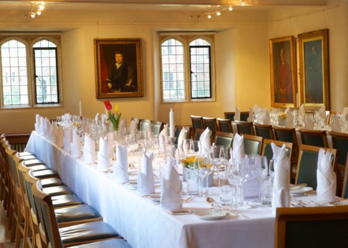 The Graham Storey Room, a spacious, historic room, set with white linen and table settings for a private dining function