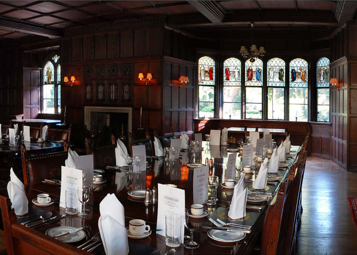 Fully wood-panelled walls with stunning tall stained glass windows and tiles framing the open fireplaces. Overlooking Fellows' Garden. Set for dining with crockery, menus and napkins. Ideal for exclusive dinners and receptions.